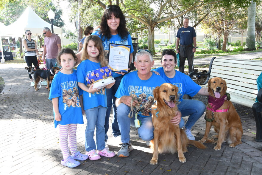 Chase Gohlke-Marino, last year's winner of the Honorary Dog Mayor contest, is surrounded by his supporters at the 22nd annual Mutt March.