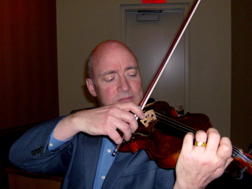 UNC Charlotte music professor David Russell plays a violin that belonged to a member of the Auschwitz Men's Orchestra.