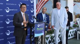 Jaehong Park, CEO of LG Energy Solution Vertech announces partnership with DTE. Detroit Regional Chamber President Sandy Baruah and DTE Vice Chairman Trevor Lauer stand to the right.