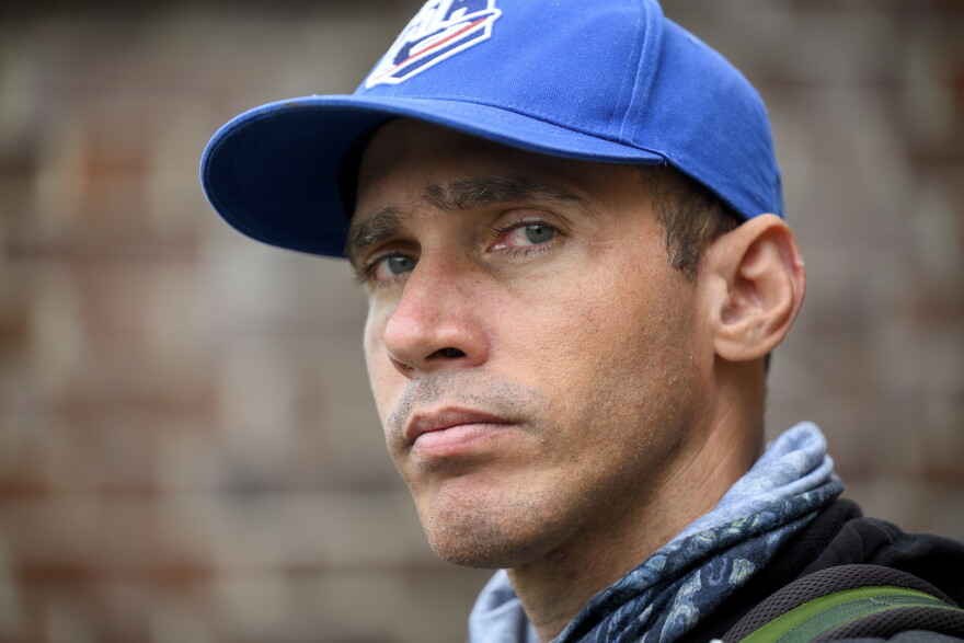 Cuban photojournalist and baseball historian Reynaldo Cruz Diaz stands for a portrait at Muzzy Field in Bristol, Conn. Cruz is now living in Connecticut as he awaits word for his request for political asylum. He left Cuba to cross the Rio Grande alone into the U.S. after being the target of threats and surveillance by the Cuban government.