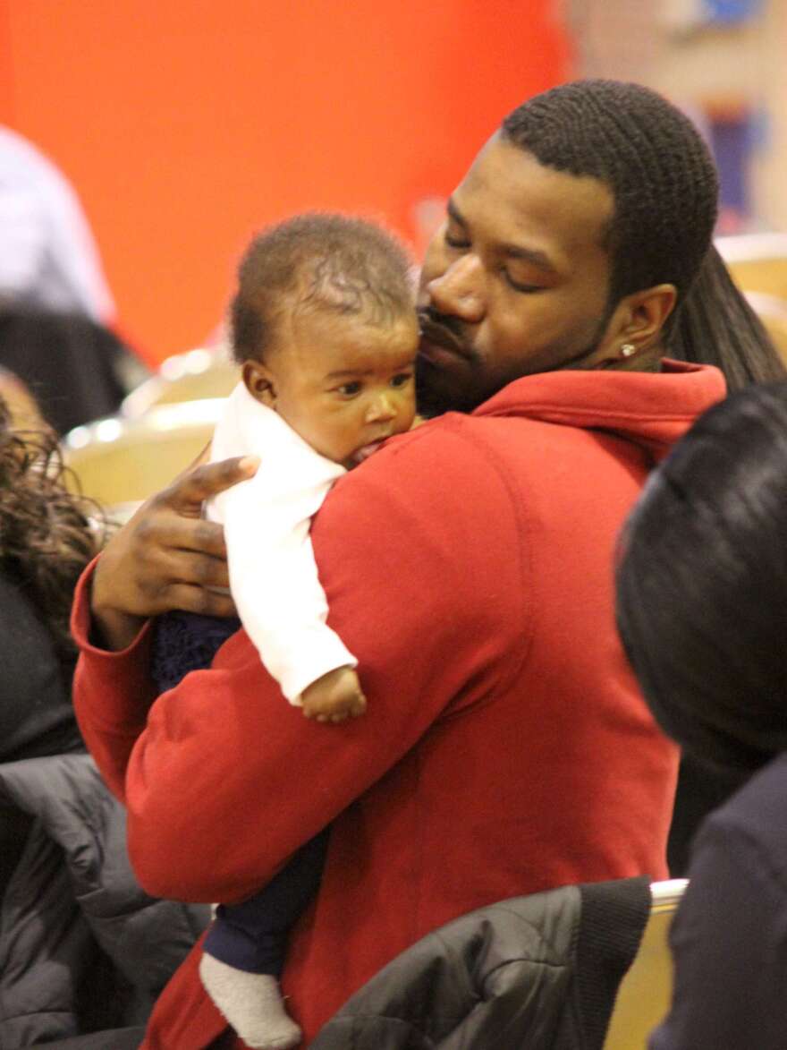 Tyrone Johnson holds his daughter, Rylee Broxton, during a recent Baby College graduation. The program teaches parents about childhood development, discipline and language skills.