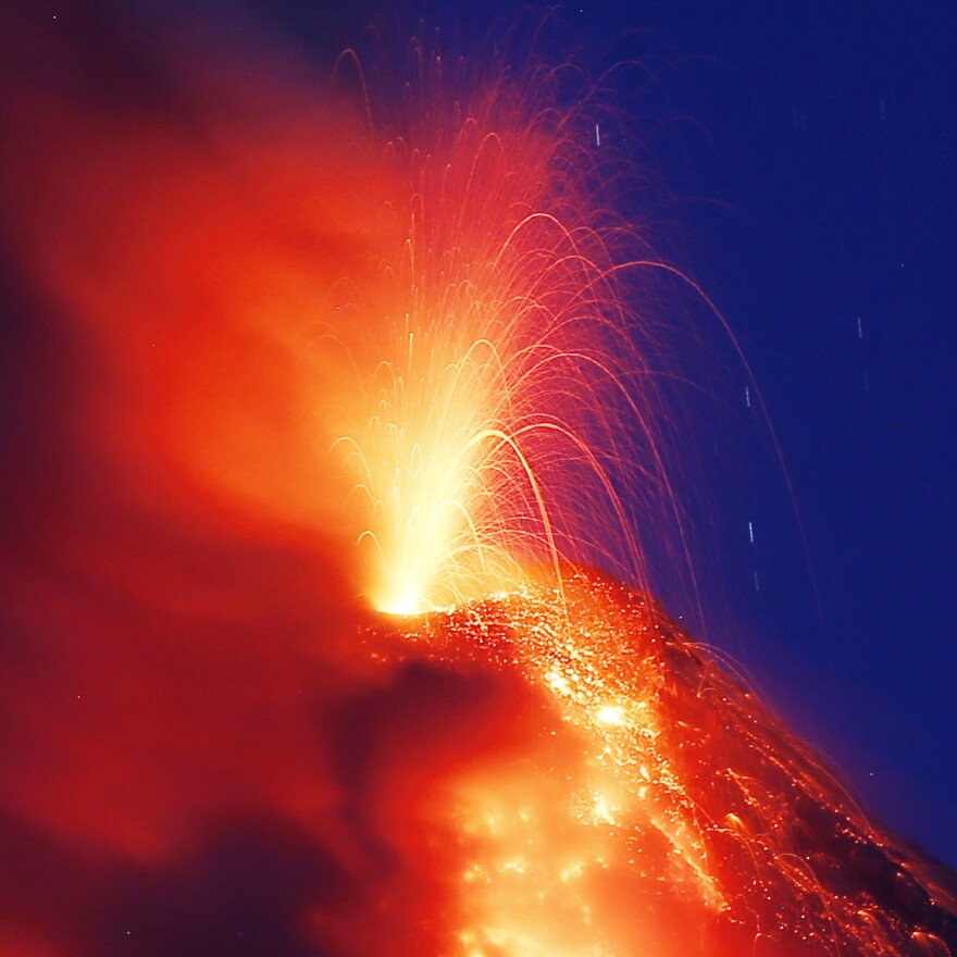 Mayon volcano erupts for the second straight day as lava cascades down its slopes on Tuesday, as seen from Legazpi city, Albay province.