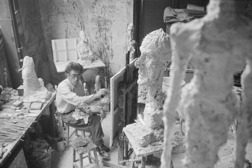 Giacometti paints in his Paris studio in 1958.