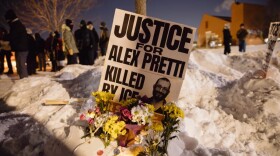A sign for Alex Pretti, who was killed earlier in the day by a U.S. Border Patrol officer, is displayed during a vigil Saturday in Minneapolis.