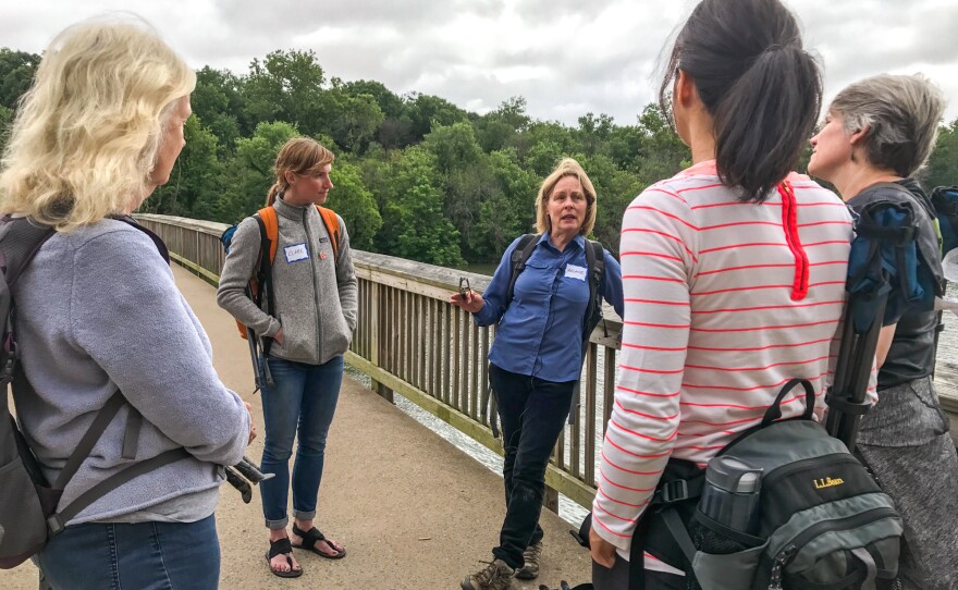 Melanie Chouckas-Bradley leads a group of five women in a forest bathing excursion. She is certified as a forest therapy guide through the Association of Nature & Forest Therapy.