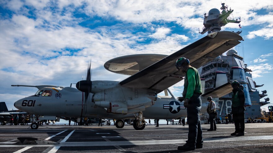 U.S. Sailors observe as an E-2D Hawkeye aircraft on USS Gerald R. Ford during Operation Epic Fury.