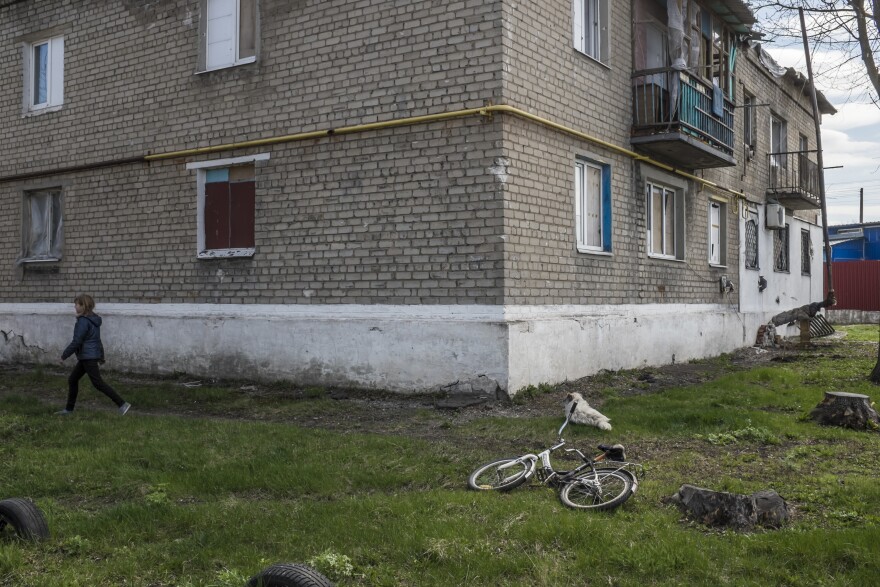 Vika, 10, walks in the yard near where she lives in Spartak, Ukraine. Despite some of the heaviest fighting of the war taking place close by and regular shelling of the neighborhood, Vika has remained in Spartak throughout the conflict.