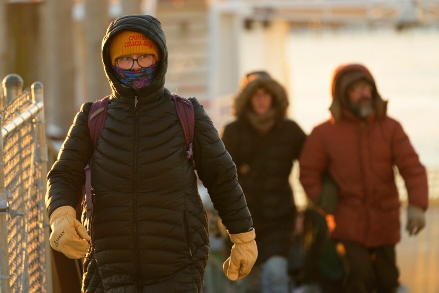 Island commuters are bundled against the cold as they disembark from a ferry on a 1-degree F. morning, Saturday, Jan. 24, 2026, in Portland, Maine.