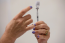 FILE PHOTO: A nurses fills up syringes for patients as they receive their coronavirus disease (COVID-19) booster vaccination during a Pfizer-BioNTech vaccination clinic.