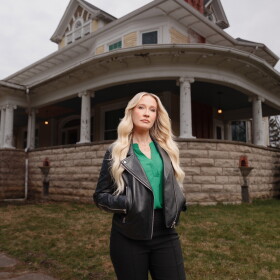 HGTV host Anna Camp stands in front of Bihl Manor in Fremont — the first haunted home to be featured on "A Very Haunted Renovation."
