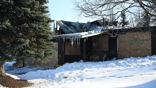 A boarded up, fire damaged home on Shore Circle on March 30, 2026. The home was the site of a shooting and residential fire that Anchorage police and fire officials responded to two days prior.