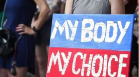 An abortion-rights supporter holds a sign at a demonstration outside the Texas Capitol on Tuesday.