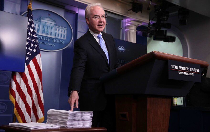 Health and Human Services Secretary Tom Price compares a copy of the Affordable Care Act (right) and a copy of the new House Republican health care bill during a White House press briefing on Tuesday.