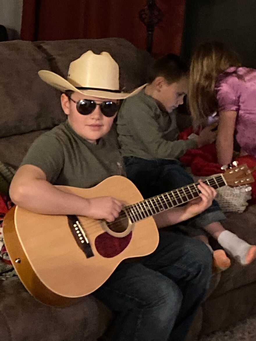 Rylan Reece poses with a guiter as a young boy
