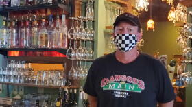 Dawson’s On Main co-owner Chris Hill stands behind the bar at his restaurant just a short walk from the Indianapolis Motor Speedway.