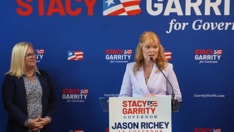 Stacy Garrity (right, at podium) spoke Aug. 27, 2026 at Family Pizza & Pub, a small restaurant in Altoona. Several other Republican state lawmakers spoke at the event as well, including Sen. Judy Ward, standing to the left. 