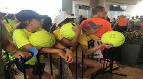 Campers from a tennis camp near Chicago wait in line for autographs in Mason in 2018.