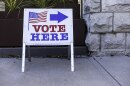 Sign reads Vote Here. 