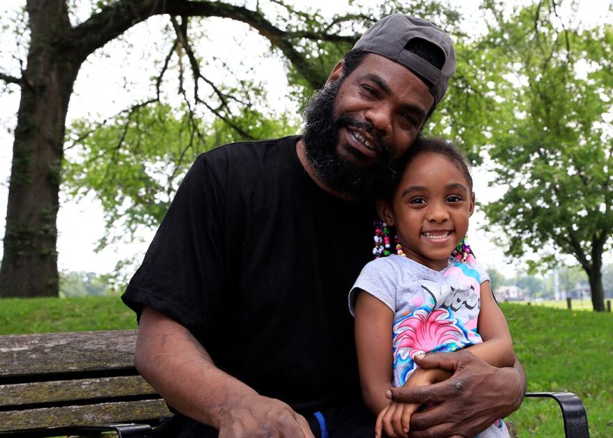 Poet Sam Stokes poses with his granddaughter Ivy in Cleveland's Luke Easter Park. [Margaret Cavalier / Ideastream Public Media]