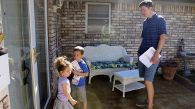 State Sen. David Holt (R-Oklahoma City) knocks doors for State Representative Jason Nelson (R-Oklahoma City) with his children Maggie and George.