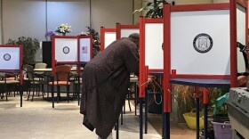 A resident of the Elliott Park apartments was the first one to vote, in his robes and slippers, on Election Day.