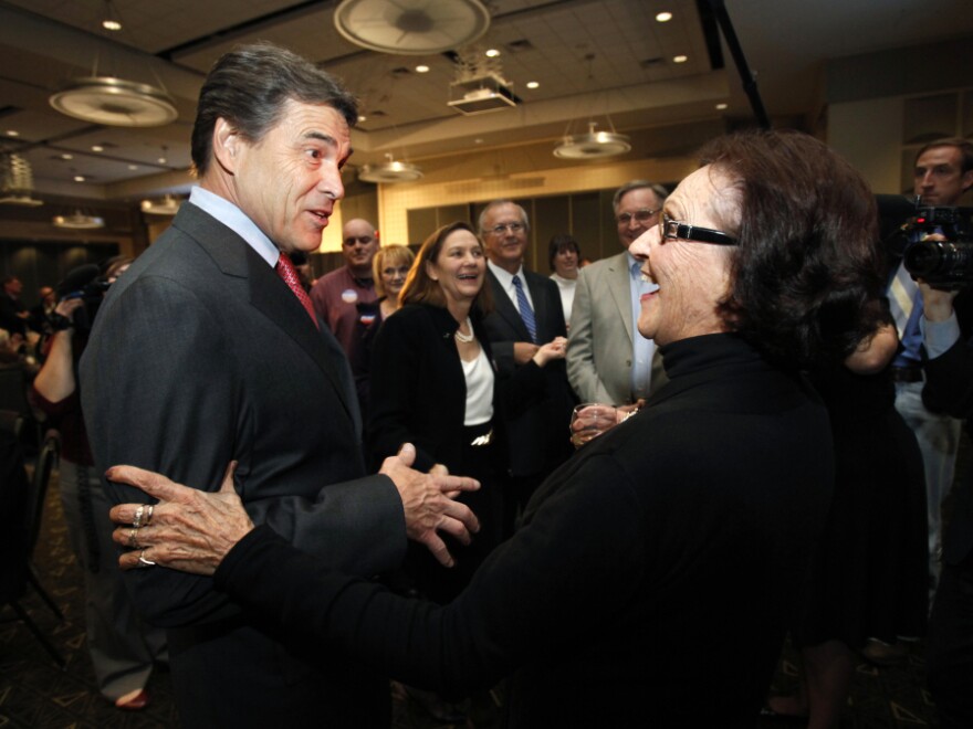 Republican presidential candidate Texas Gov. Rick Perry talks with voter Jane High before speaking at the Scott County Republican party's Ronald Reagan Dinner on Nov. 14 in Bettendorf, Iowa.