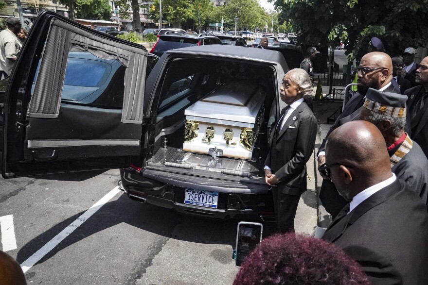 Rev. Al Sharpton stands next to a hearse carrying the casket of Jordan Neely after a funeral service at Harlem's Mount Neboh Baptist Church, Friday May 19, 2023, in New York. Neely, a former Michael Jackson impersonator who had been struggling with mental illness and homelessness in recent years, died May 1 when a fellow subway rider pinned him to the floor of a subway car in a chokehold that lasted several minutes. (AP Photo/Bebeto Matthews)