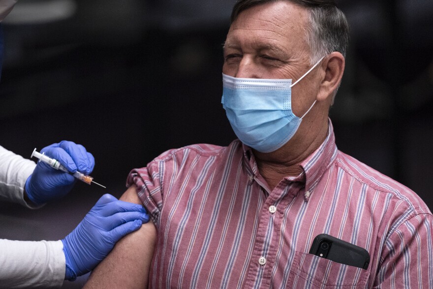 Forest Weston receives the first shot given at a newly-opened COVID-19 vaccination clinic on Wednesday, March 17, 2021, in Auburn, Maine. The high-volume vaccination site was opened by Central Maine Healthcare, the City of Auburn, the City of Lewiston and the State of Maine. The clinic is currently using the Moderna vaccine.