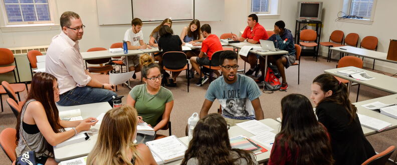 Dr. Bell sits with students.