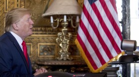 During a Christmas Eve video teleconference, President Trump speaks with members of the military from his Mar-a-Lago estate in Palm Beach, Fla. CREDIT: Andrew Harnik/AP