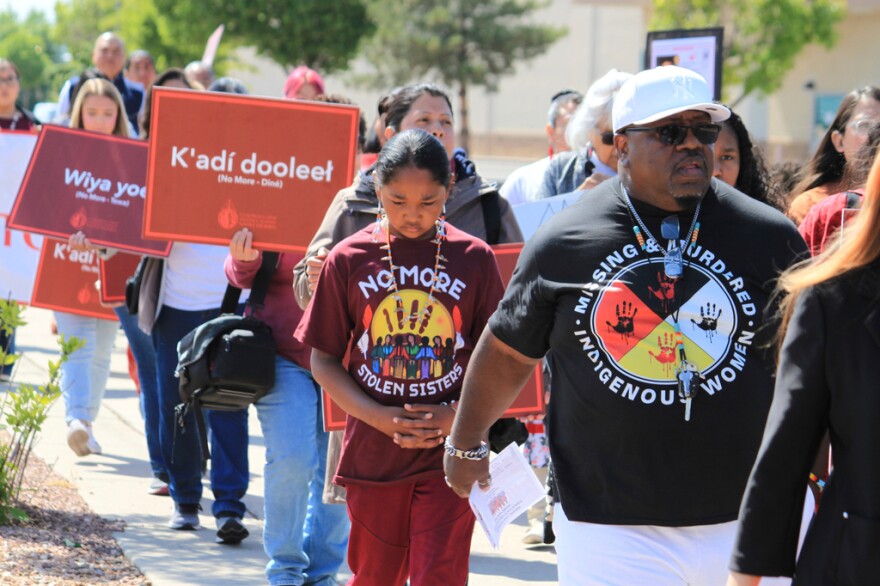 Tize W. Clark, right and his son, Zion Clark, participate in a walk to honor Native American and Indigenous relatives who have gone missing or have been killed as Missing and Murdered Indigenous Persons Awareness Day is marked in Albuquerque, New Mexico, on May 5, 2025.