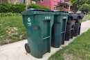 Two curbside recycling carts next to trash cans in Cincinnati's Clifton neighborhood.