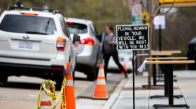 In this March 2020 file photo, customers at Trophy Brewing in Raleigh are directed to remain in their cars to receive service. 