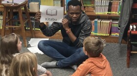 Bridges volunteer teachers kids the word for "book" in Swahili.
