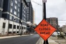 Road closed ahead sign near the construction site of a high rise apartment on College Ave. 