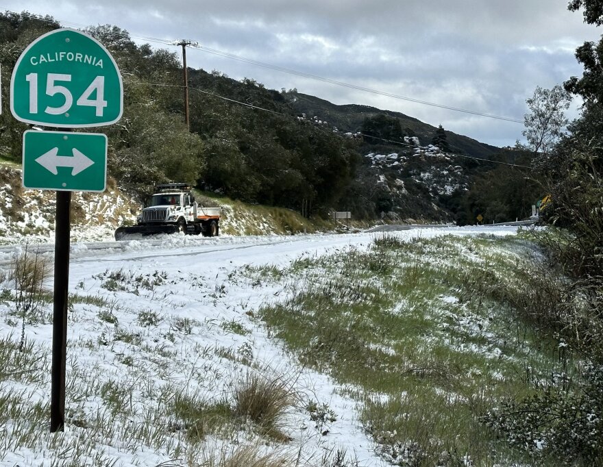 A Caltrans truck clears snow from Highway 154 Thursday afternoon