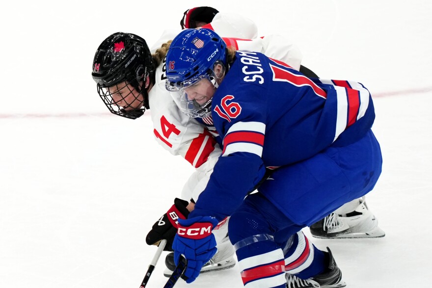 United States' Hayley Scamurra (16) and Canada's Renata Fast (14) skate after the puck during the first period of the women's ice hockey gold medal game at the 2026 Winter Olympics, in Milan, Italy, Thursday, Feb. 19, 2026. (AP Photo/Carolyn Kaster)