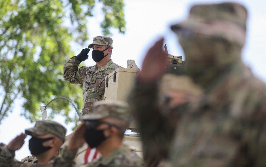 U.S. Army soldiers salute during tributes following the drive-by birthday party for World War II veteran Lt. Colonel Sam Sachs, who turned 105 today, amid the coronavirus pandemic on April 26, 2020 in Lakewood, California. (Mario Tama/Getty Images)