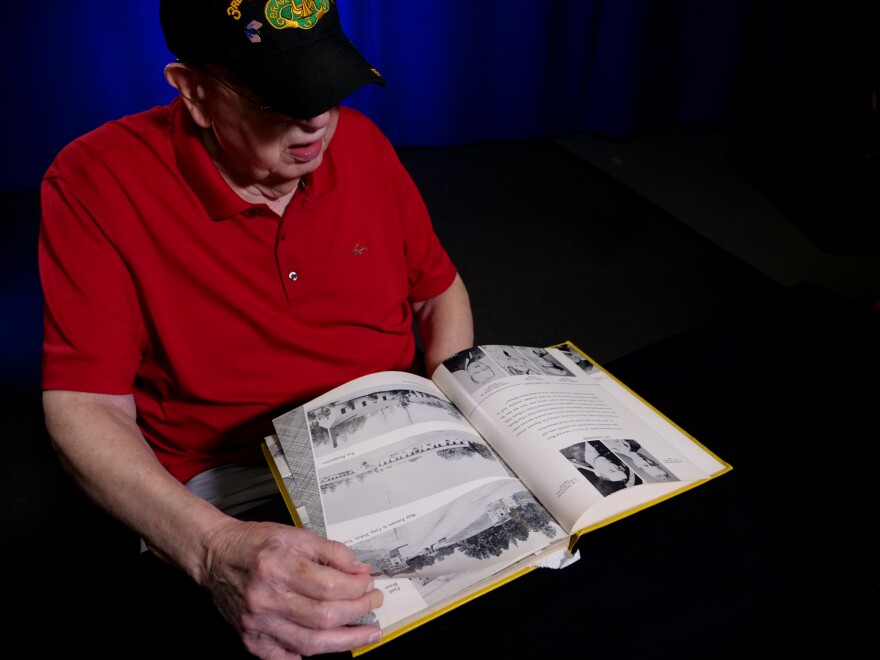 Tom Lambert looks through his unit's yearbook.