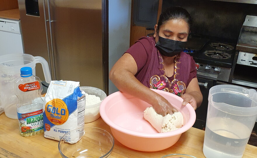 Isabel kneads the masa and water until it feels perfect.