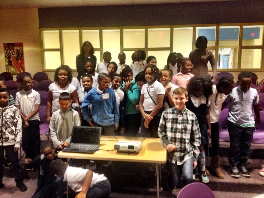 Students at Miner Elementary in Washington, D.C. post with Alaska visitors Jack Hickox and Nolan Quigley, on either side of the table.