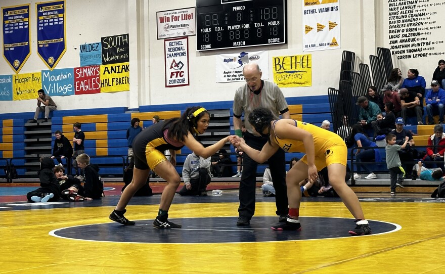 Avalos, on the right, shakes hands with her opponent before the start of the 152-pound finals.