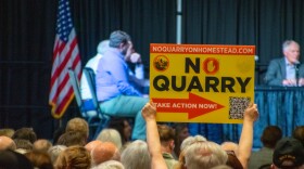 One attendee holds up a sign that reads 'No Quarry' in front of the Allen County Board of Zoning Appeals on Tuesday. A group of residents near the proposed quarry area fundraised for signs and other marketing materials to hand out at the meeting.