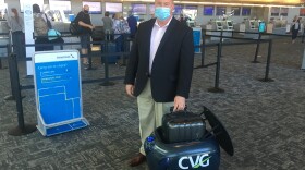 CVG Chief Innovation Officer Brian Cobb tries out Gita the robot.