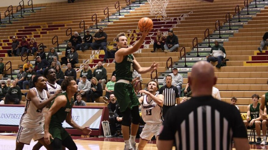 Action shot of Wes Dreamer vs Emmanuel basketball
