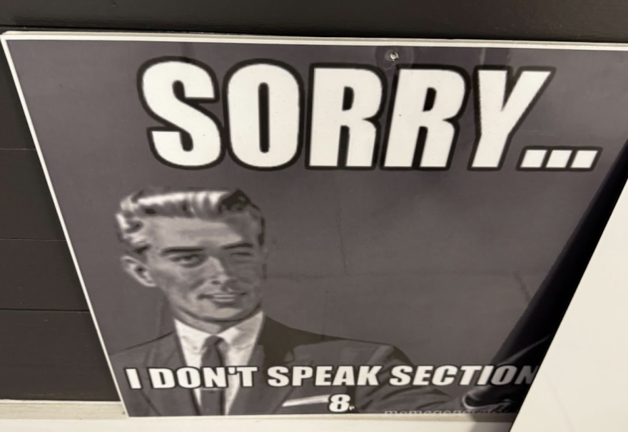 Black and white sign of man saying "Sorry...I don't speak Section 8." 