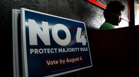 Alphanse Boure, right, pauses while joining his family in canvasing against Amendment 4 at Stevie’s Jailhouse Kitchen on Sunday, Aug. 2, 2026, in St. Louis’ Baden neighborhood.