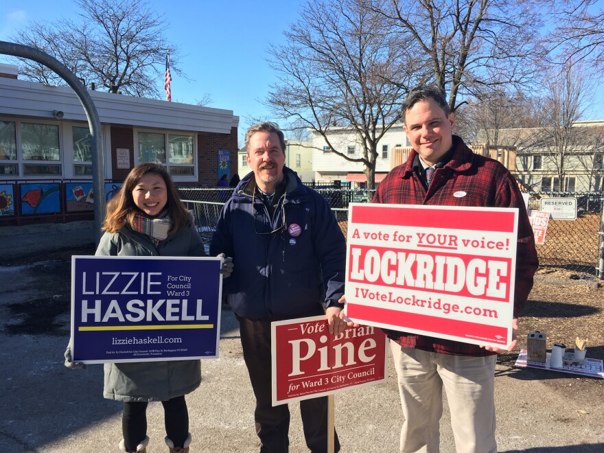 Candidates running for Burlington City Council in Ward 3 hold up their signs at the Sustainability Academy. From left, Elizabeth "Lizzie" Haskell, Brian Pine and James Lockridge.