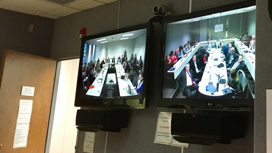 Video monitors of commission meeting