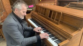 Stephen Merriman plays one of the many pianos in his shop, Merriman's Piano, on March 27, 2020.